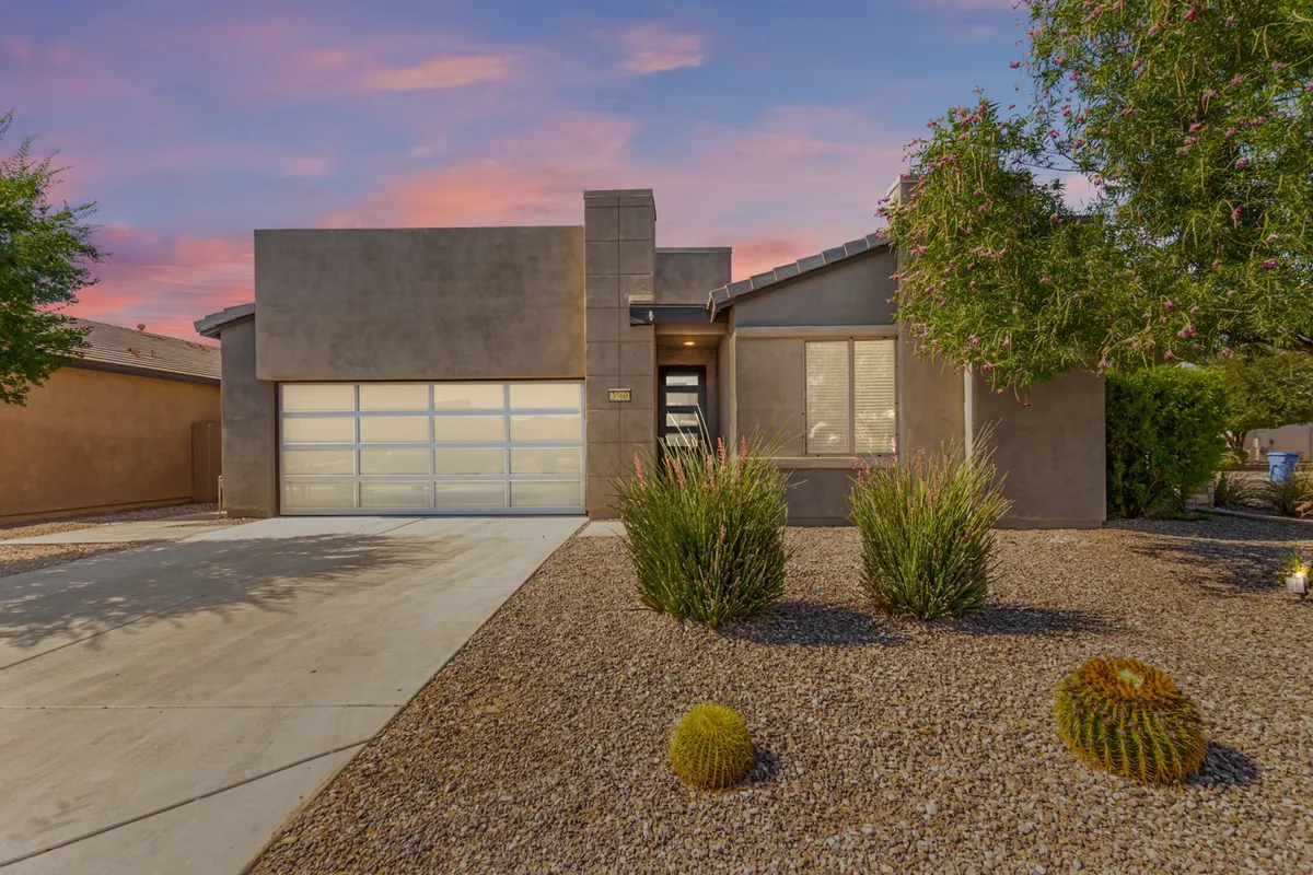 The modern exterior of the home is highlighted with a landscaped front yard and a prominent garage door. The driveway provides ample parking, while the welcoming architectural design sets the stage for comfortable living and easy outdoor access.